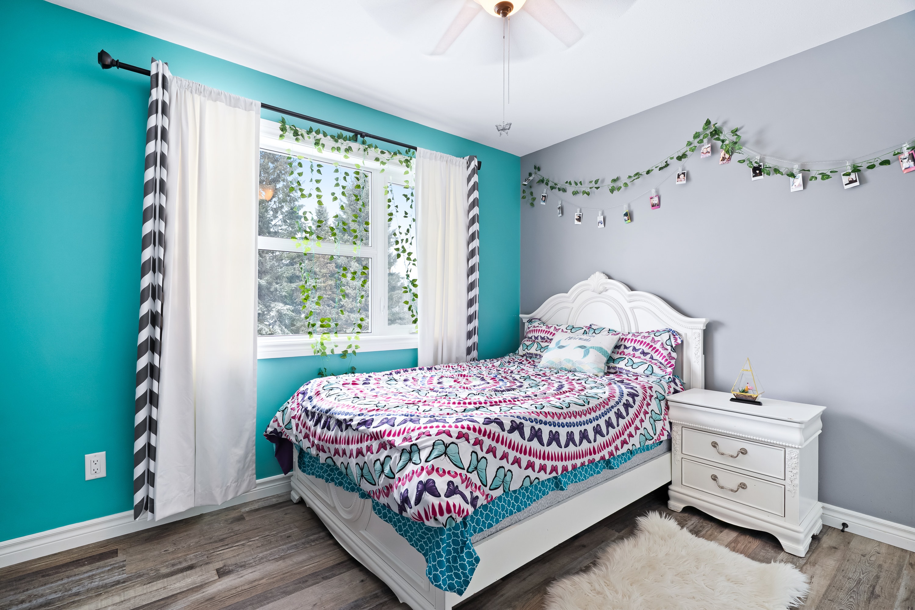 Lake house bedroom with turquoise accent wall