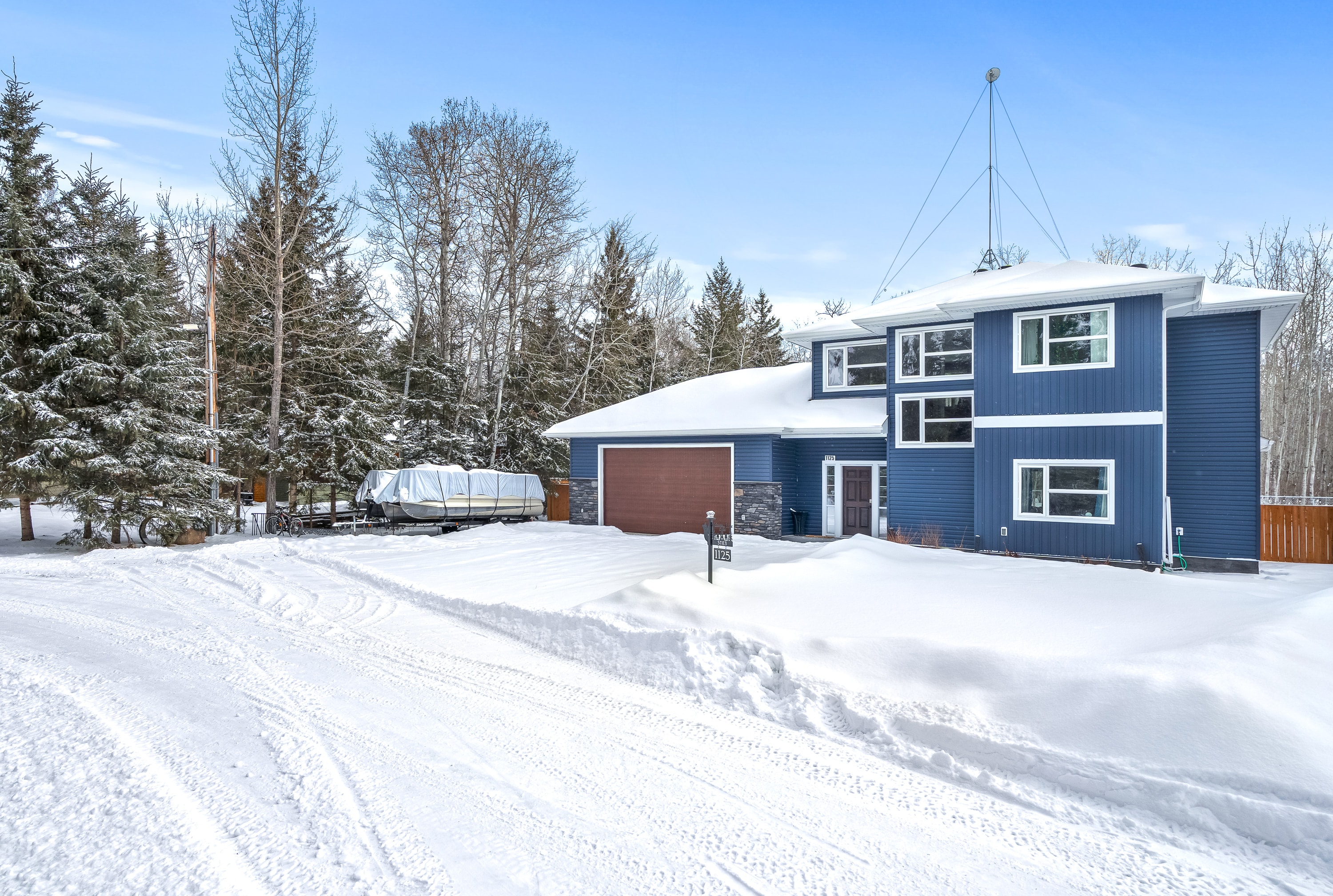 Blue Lake House exterior surrounded by snowy forest