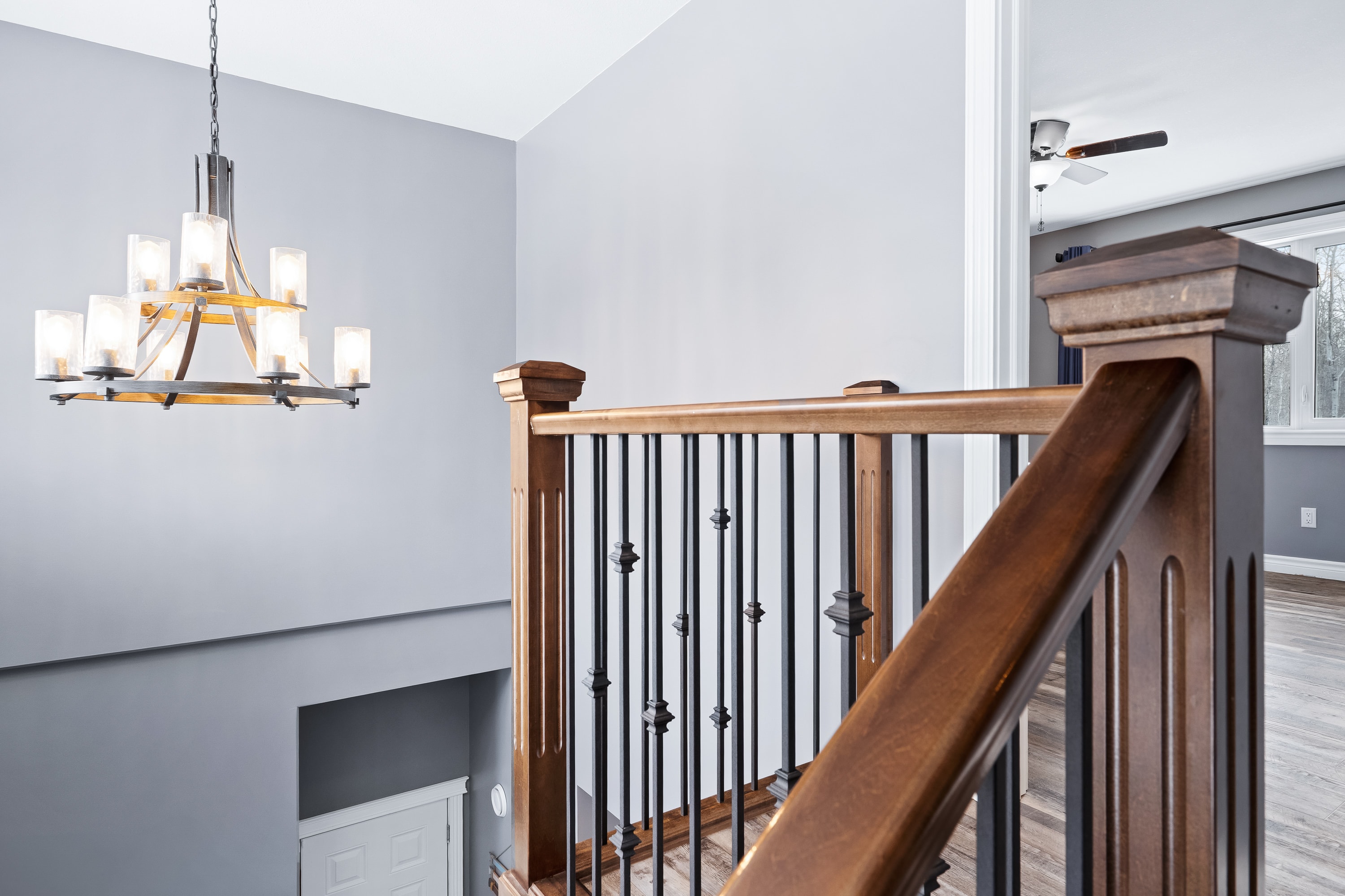 Lake house staircase detail with dark wood railings